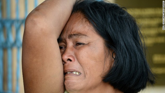 A woman mourns her dead son at a chapel in the aftermath of Super Typhoon Haiyan in Tacloban, eastern island of Leyte on November 9, 2013. 