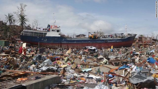 A large boat sits aground surrounded by debris in Tacloban on November 10.