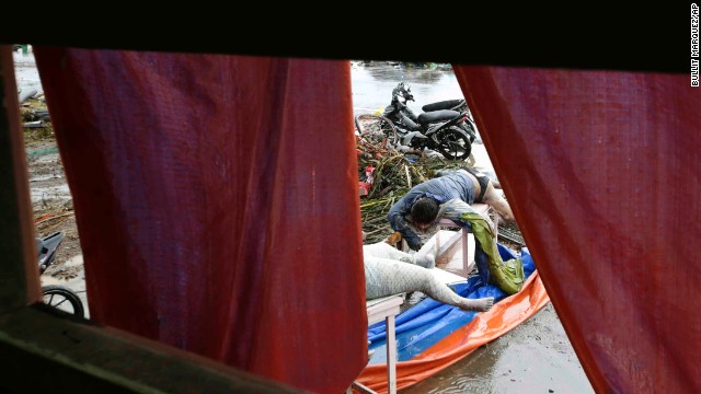 Bodies of victims lie along a Tacloban road on November 10.