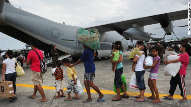 Survivors of Typhoon Haiyan line up at the airport in Tacloban, Philippines, to board a U.S. military C-130 for Manila on Monday, November 11. One of the strongest storms in recorded history, Haiyan laid waste to the Philippines. Officials say that as many as 10,000 people may have died in the storm.