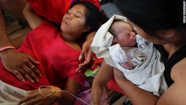 Emily Ortega rests on November 11 after giving birth to Bea Joy at an improvised clinic at the Tacloban airport.