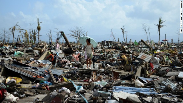 A woman in Tacloban walks amid the debris of destroyed houses on November 11.