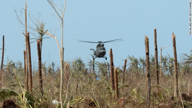 A military helicopter delivering food prepares to land at the airport in Guiuan on November 11.