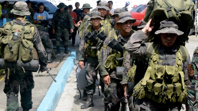 Philippine police commandos prepare to board a military plane in Manila on Sunday, November 10.