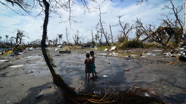 Two young boys look at the devastation in Tacloban on November 10.