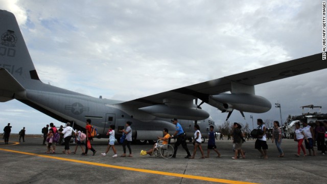 Survivors in Tacloban board a military plane bound for the Philippine capital of Manila on November 11.