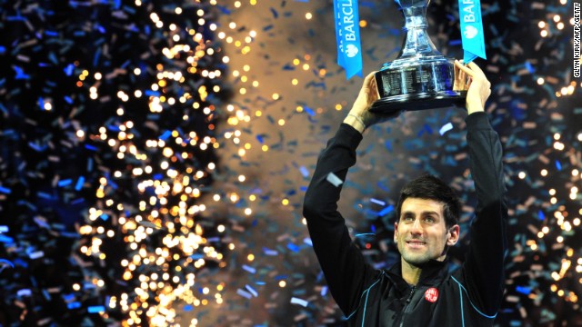 Novak Djokovic lifts the Brad Drewett trophy after beating Rafael Nadal in the final of the ATP World Tour Finals.