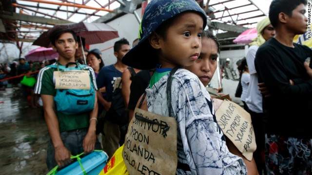 Survivors wait to board a military plane November 12 in Tacloban.