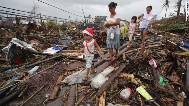 Survivors walk in Tacloban on November 12.