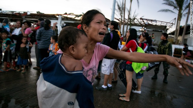  A woman cries November 12 as other survivors wait to evacuate Tacloban.