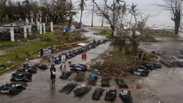 Police line up bodies for processing in Tacloban on November 12.