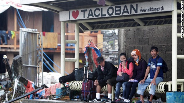 People wait at a bus stop November 12 in Tacloban, Philippines.