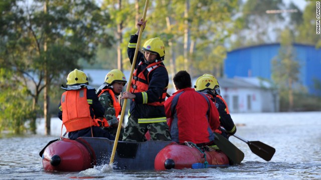Rescuers in Guigang City, China, search a flooded road by boat on November 12. China and Vietnam were also hit hard by the typhoon.