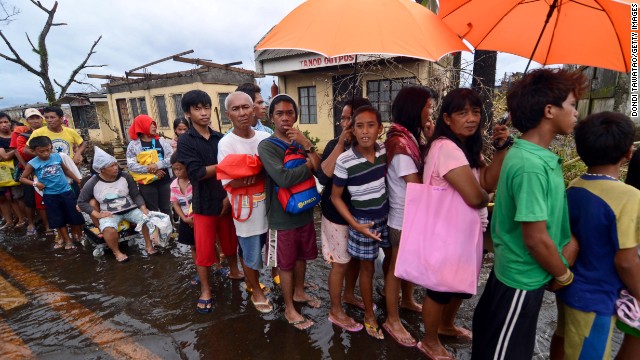 People wait in line to receive relief goods in Leyte on Tuesday, November 12.