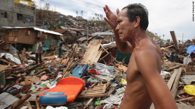 A man looks at his home destroyed by Typhoon Hayian in Tacloban on November 13.