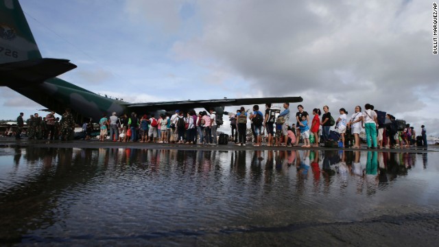 Survivors prepare to board a military plane November 13 at the Tacloban airport.