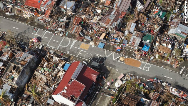 An aerial view shows signs pleading for help and food scrawled on a road in the coastal town of Tanauan on November 13.