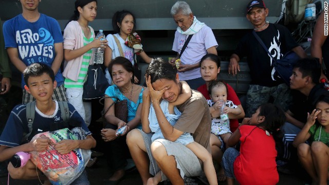 Survivors wait to be evacuated from Tacloban on November 13.