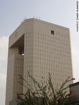 Architect: Nikken Sekkei Ltd.<!-- -->
</br>The two towers of the Islamic Development Bank Headquarters in Jeddah are connected by a roof structure. <!-- -->
</br>The building, which is over 100 meters tall, has a sophisticated design: narrow window slits in the outer walls serve to block the strong sunlight while the central patios are covered in glass in order to let in natural light.