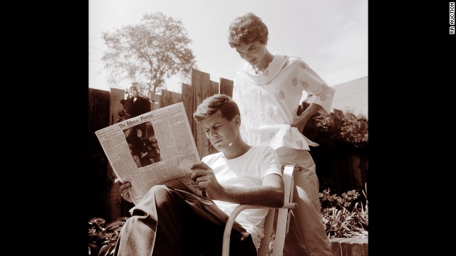 Jackie looking over John's shoulder as he reads the May 7 issue of the Christian Science Monitor on May 9, 1954, Mother's Day.