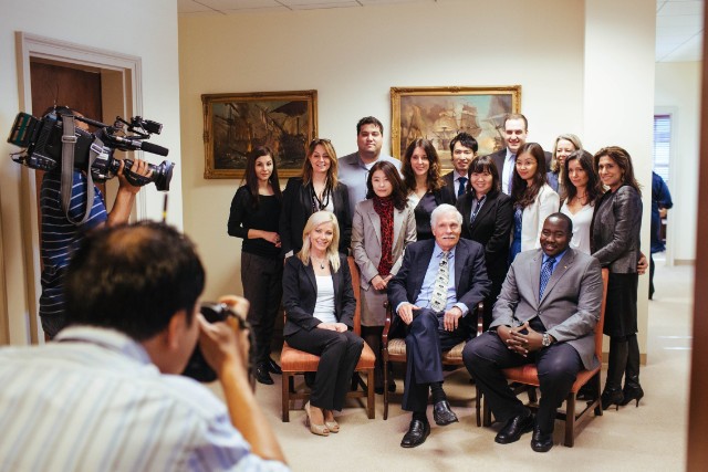 The former media mogul poses with this year's CNN Journalism Fellows -- his last connection to the 24-hour global news channel he founded in 1980. border=