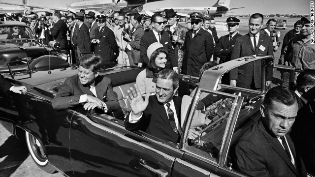 About 11:45 a.m., Texas Gov. John B. Connally Jr., waving to the crowd, and the Kennedys depart Love Field for a 10-mile tour of Dallas. The President asked about the weather earlier in the day and opted not to have a top on the limousine. 