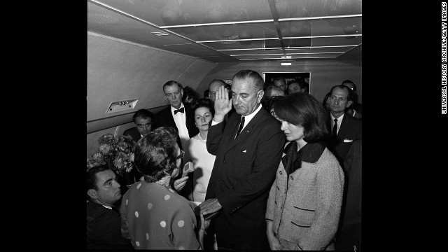 Vice President Lyndon Johnson takes the oath of office to become the 36th president of the United States. He is sworn in by U.S. Federal Judge Sarah T. Hughes, left, with Jacqueline Kennedy by his side on Air Force One. 