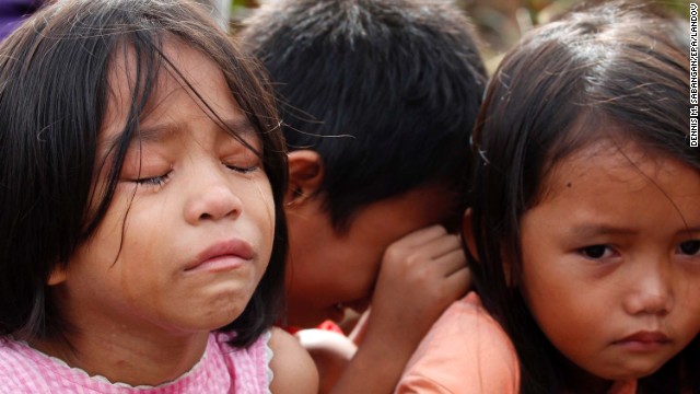 Survivor children, who escaped after their village was attacked by allegedly armed men, wait for social workers in Tacloban on November 13.