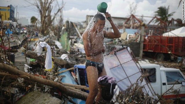 A man takes a shower amid the rubble in Tacloban on November 13.