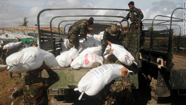Soldiers load relief goods onto a truck in Tacloban on November 13. 