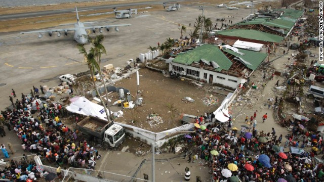 Stranded passengers board a plane at a damaged airport in Tacloban, Philippines, on Wednesday, November 13.