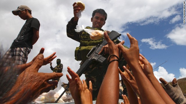 A Filipino soldier hands out bread to survivors in Maraboth, Philippines, on November 14.