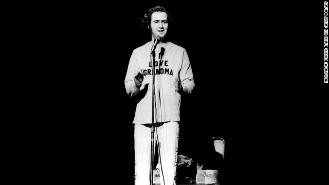 Andy Kaufman onstage in 1977, wearing a "I love grandma" sweater after doing one of his trademark Elvis impersonations.