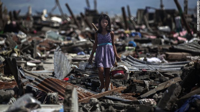 Nina Duran searches for belongings at her family's destroyed house in Tacloban on November 13.