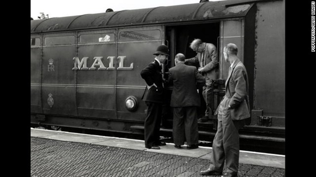 Detectives inspecting the Royal Mail train from which more than £2.5 million was stolen. The Great Train Robbery took place in Buckinghamshire on August 8,1963, when the train from Glasgow to London was halted by a gang.