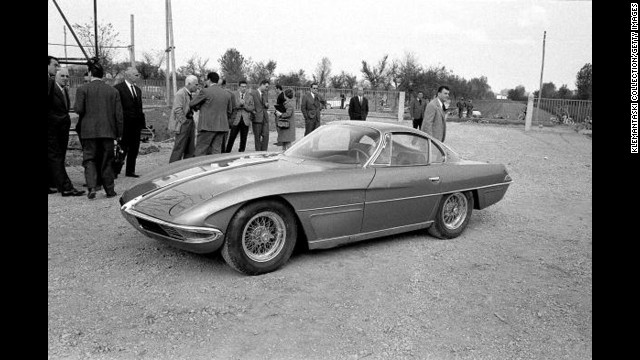 The Lamborghini 350GTV with the body by Franco Scaglione is launched at the Lamborghini Factory, Sant'Agata, Italy, in October 1963. Among the onlookers, with white hair and light-colored jacket, is Piero Taruffi, winner of the last Mille Miglia in 1957. 