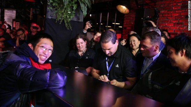 Joey Chiu, 24, of Brooklyn, left, buys the first PlayStation 4 sold in North America at a launch event presented by Sony Entertainment Network on November 14 in New York City.