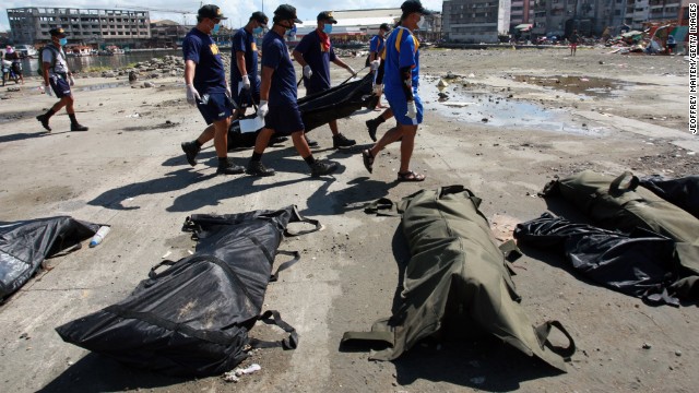 Search and retrieval teams carry a body bag in Tacloban on November 15.