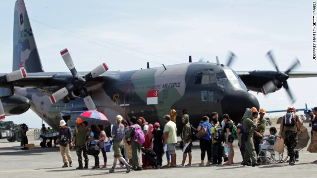 Residents wait to board a Singaporean cargo plane at the Tacloban airport on November 15. Many survivors have converged on the city's airport to wait for flights.