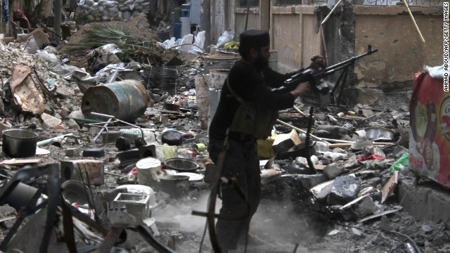 A rebel fighter fires his weapon as he stands amidst rubble and debris during clashes with Syrian government forces in Deir Ezzor, Syria on November 11. More than 100,000 people have been killed, according to the United Nations, and millions uprooted from their homes and tens of thousands trapped by the relentless fighting since 2011. Click through to view the most compelling images taken since the start of the conflict.