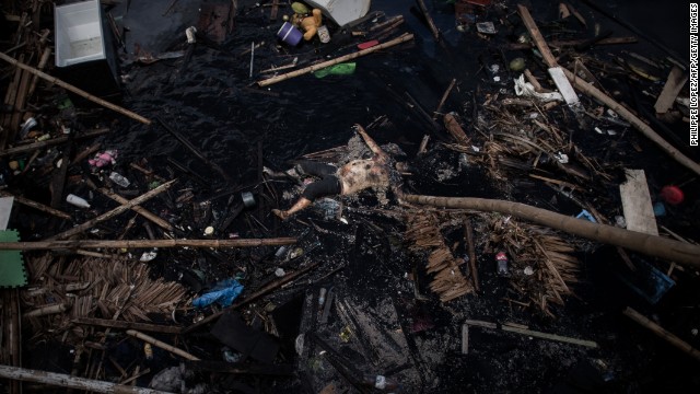 The corpse of a victim of the typhoon floats on a river in Tanauan, on the eastern island of Leyte on November 16.