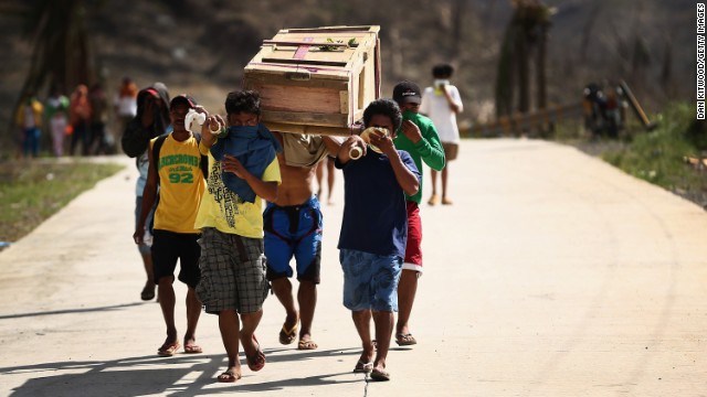 Men carry a coffin toward a local cemetery on November 16 in Leyte, Philippines. Bodies are still being collecting from streets.