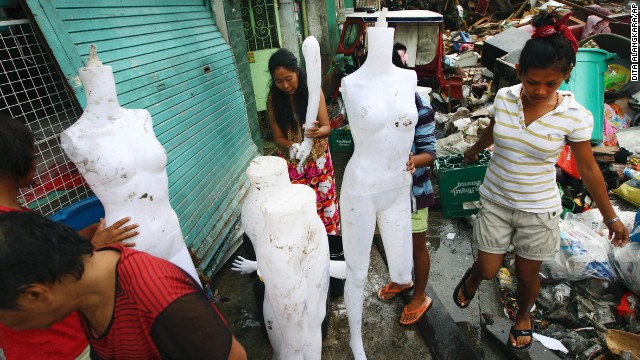Survivors clean mannequins found among the debris in Tacloban on November 17.