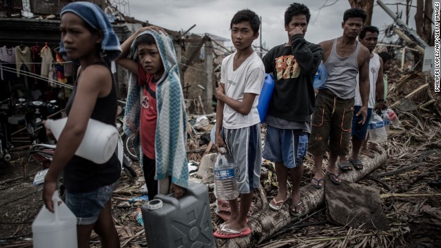People wait in line for drinking water November 17 in Palo, Philippines.