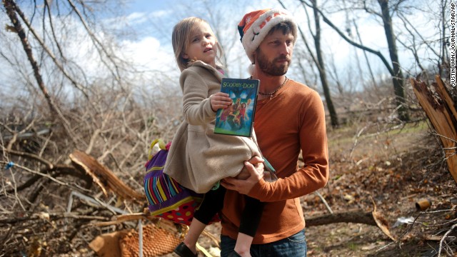 Billy Vestal evacuates his home in East Peoria, Illinois, with his 3-year-old daughter, Lillian Vestal, after a tornado damaged the area on November 17.