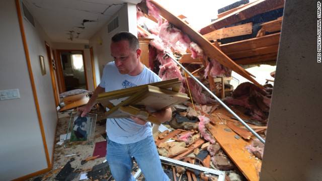 Josh Ramsey recovers items from the house of a family friend after a tornado tore through the north end of Pekin, Illinois, on November 17.