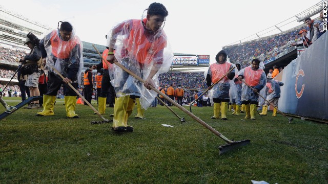 Members of Soldier Field's ground crew prepare the field to resume play after a severe storm blew through the area on November 17 and suspended play during the first half of the game between the Chicago Bears and Baltimore Ravens.