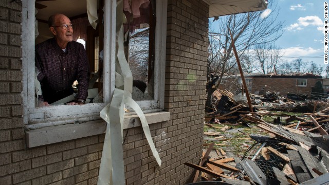 Chuck Phillips looks out at the destruction that tore off part of his roof and destroyed homes in his neighborhood on November 17 in Pekin.