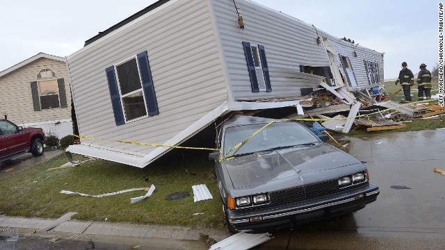 Firefighters look over damage to trailers at Summit Village, east of Marion, Indiana, after storms blew through Marion and Grant County, northeast of Indianapolis, on November 17.