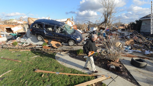 Richard Miller salvages items from his brother's home in Washington, Illinois, on November 17.